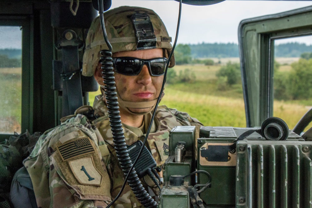 Sfc. Aaron Marcus, an Observer Controller Trainer (OCT) assigned to the Joint Multinational Readiness Center (JMRC) monitors communications during a Combined Resolve training exercise in Grafenwoehr Training Area, August, 8, 2019.