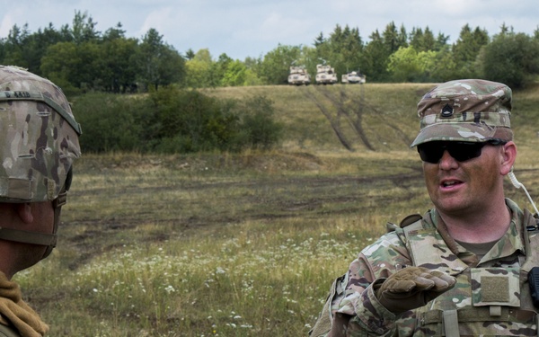 Sfc. Timothy Paddock, an Observer Controller Trainer (OCT) assigned to the Joint Multinational Readiness Center (JMRC) conducts an After Action Review (AAR) with the 1st Brigade 1st Infantry Division (ID)