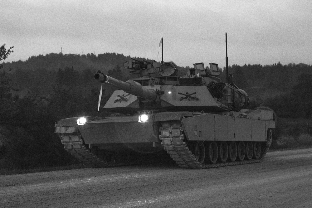 M1A2 Abram tank Troops drive down the road during a Combined Resolve training exercise in Grafenwoehr Training Area, August, 8, 2019.