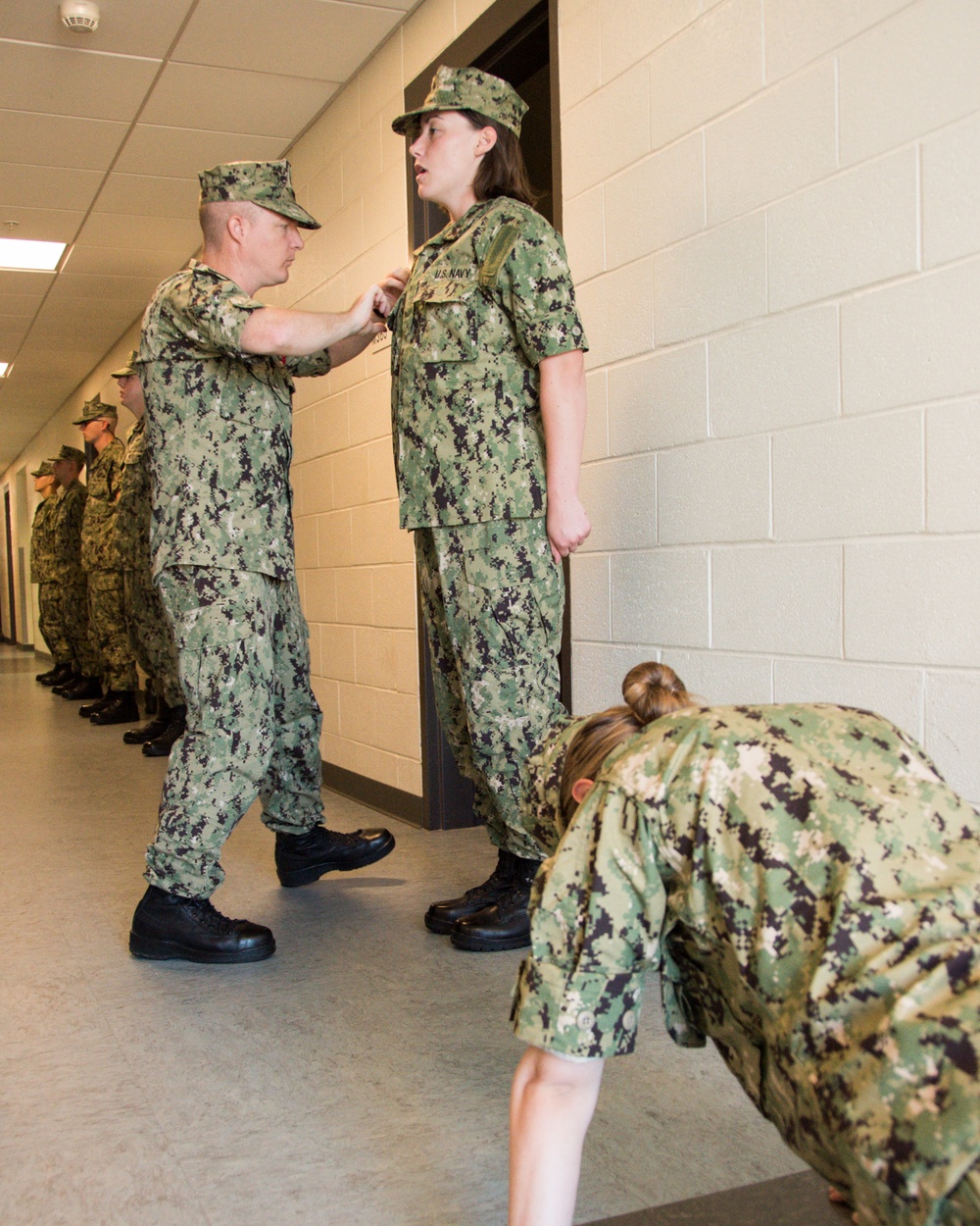 Recruit Division Commanders and Marine Corps Drill Instructors here at Officer Training Command in Newport, Rhode Island (OTCN) conducts the Navy Working Uniform inspection for Officer Candidate School (OCS) class 01-20 on Aug. 9, 2019.