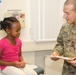 Medic takes child's vitals during back-to-school event in Baumholder