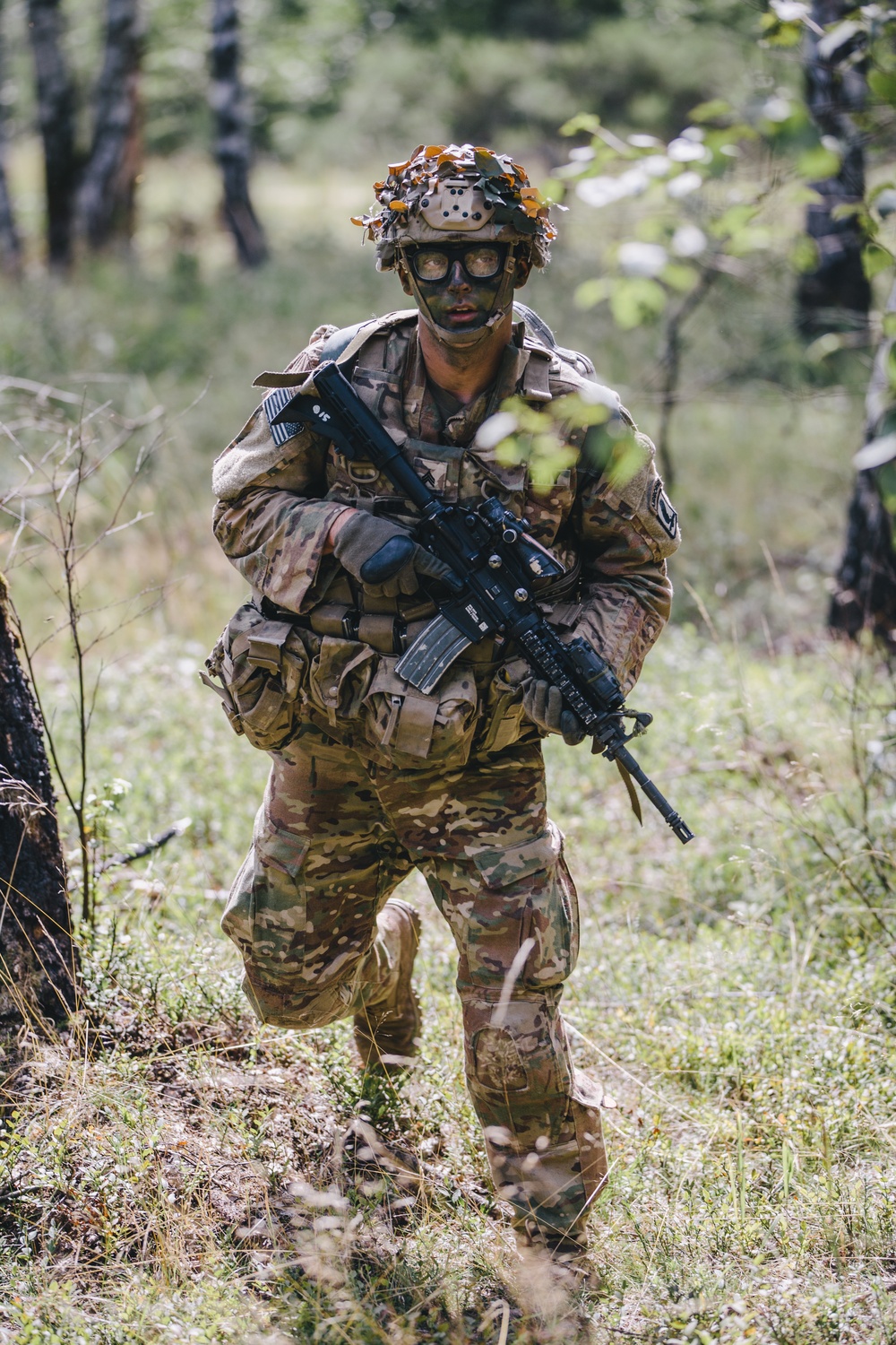 Soldier moves through woods