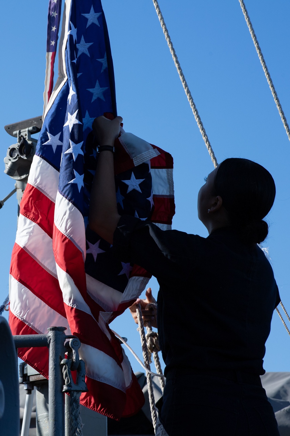 Sailor raises American flag