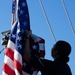 Sailor raises American flag