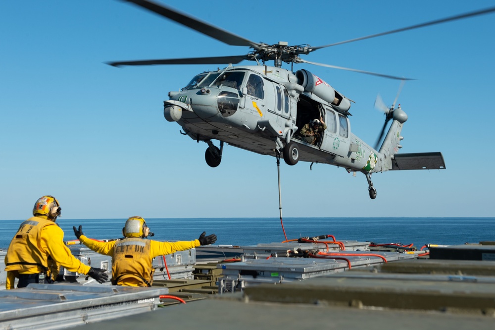 U.S. Sailors direct an MH-60S Sea Hawk