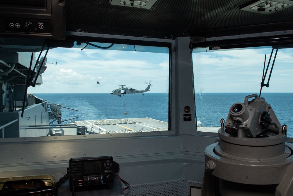 An MH-60S Sea Hawk, assigned to Helicopter Sea Combat Squadron (HSC) 7, transports ammunition from the aircraft carrier USS John C. Stennis (CVN 74) to the aircraft carrier USS Dwight D. Eisenhower (CVN 69)
