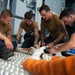 U.S. Sailors splice an eye into mooring lines.