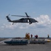 An MH-60S Sea Hawk transports ammunition