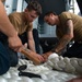 U.S. Sailors splice an eye into mooring lines.