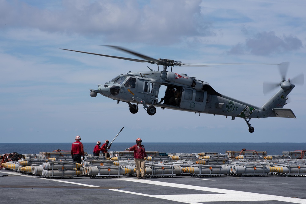 An MH-60S Sea Hawk transports ammunition