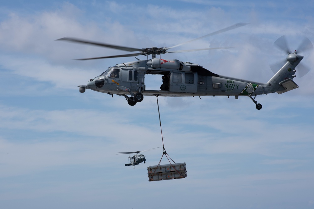 An MH-60S Sea Hawk transports ammunition