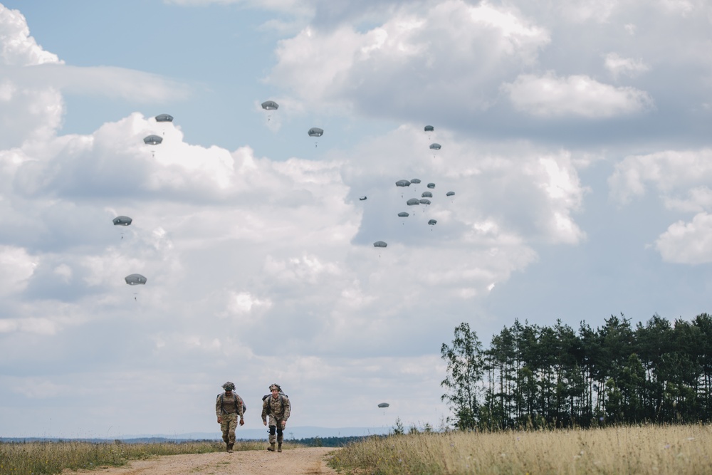 U.S. Army paratroopers move from drop zone
