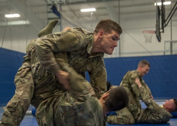 Spc. Collin George practices Modern Army Combatives with Spc. Kalon Williams