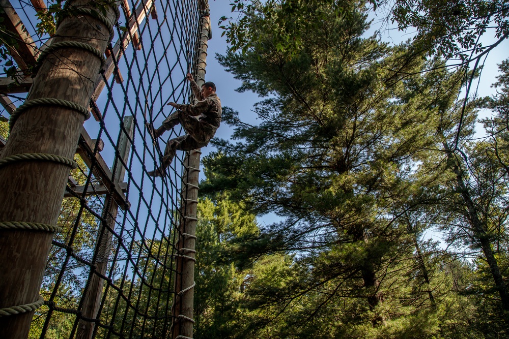 Spc. Kalon William climbs down an obstacle