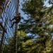 Spc. Kalon William climbs down an obstacle