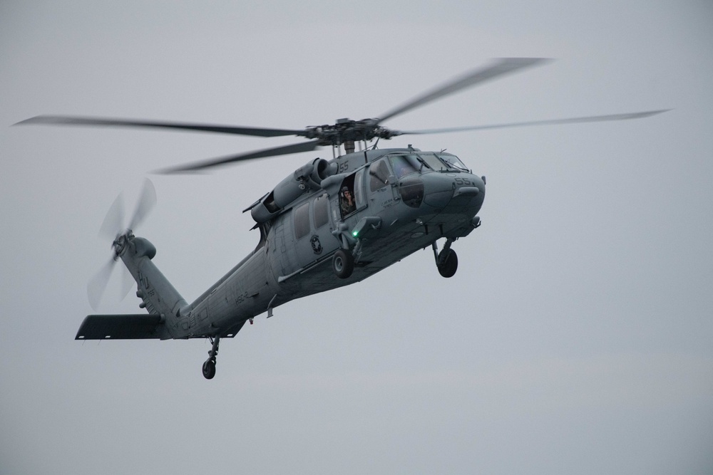 An MH-60S Sea Hawk, assigned to Helicopter Sea Combat Squadron (HSC) 2, approaches the aircraft carrier USS John C. Stennis (CVN 74)