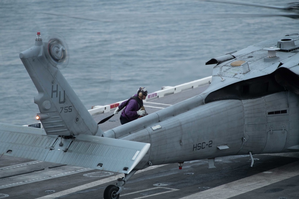 U.S. Sailor prepares to fuel an aircraft