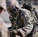 U.S. Army paratrooper navigates a concertina wire fence