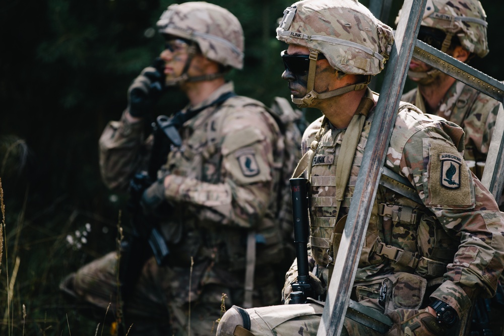 U.S. Army paratroopers prepare to navigate an obstacle