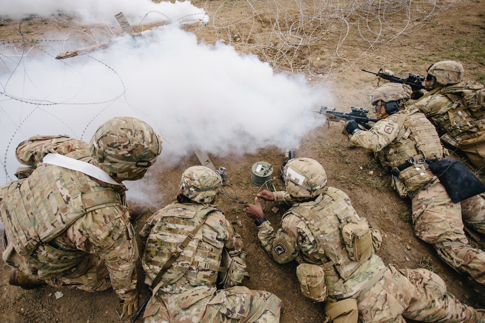 U.S. Army paratroopers rig an explosive