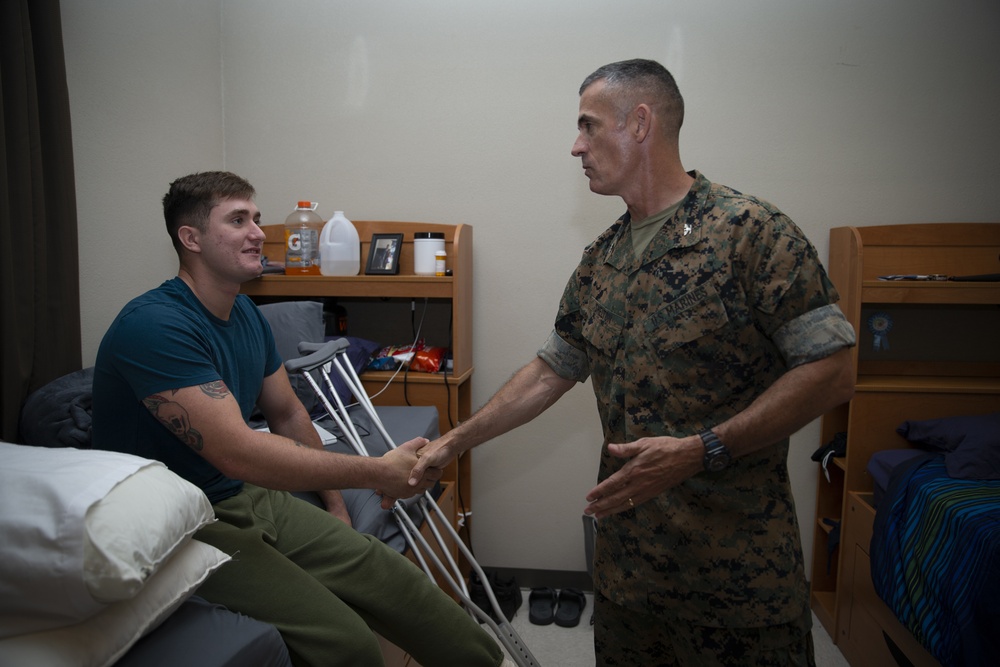 Col. James L. Shelton Jr. visits and awards Lance Cpl. Braxton Goff with the Marine Corps Combat Service Support Schools Challenge Coin For Exceptional Performance