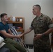 Col. James L. Shelton Jr. visits and awards Lance Cpl. Braxton Goff with the Marine Corps Combat Service Support Schools Challenge Coin For Exceptional Performance