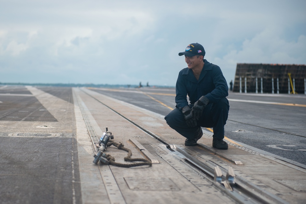 U.S. Navy Sailor prepares to perform maintenance