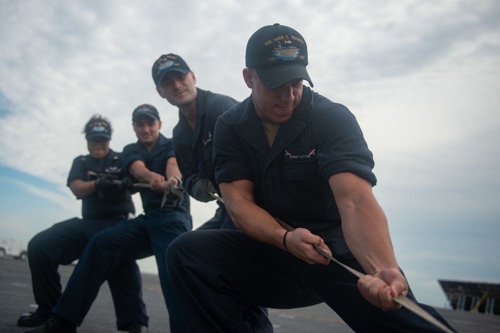 U.S. Navy Sailors pull combing