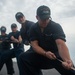 U.S. Navy Sailors pull combing