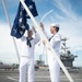 U.S. Navy Sailors lower the Union Jack