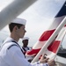U.S. Sailors lower the American flag on the aircraft carrier USS John C. Stennis