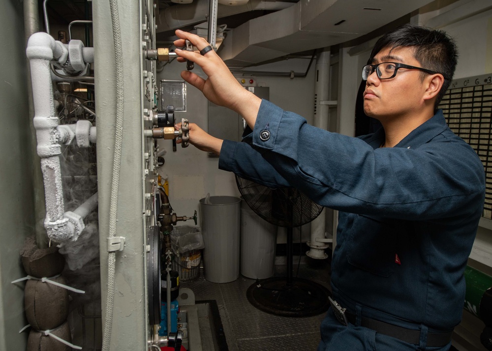 U.S. Sailor transfers liquid oxygen to a cryogenic pump