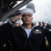 U.S. Navy Religious Programs Specialist 1st Class Timothy Cambiado, from Virginia Beach, Virginia, salutes during a burial at sea