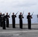 U.S. Sailors conduct a 21-gun salute during a burial at sea