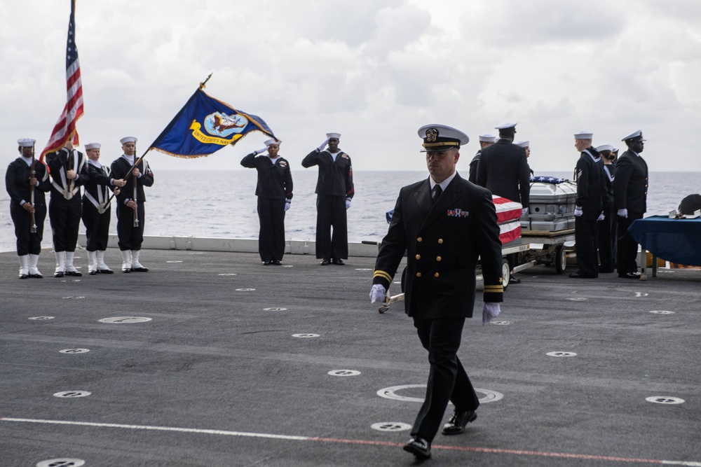 U.S. Sailors conduct a burial at sea