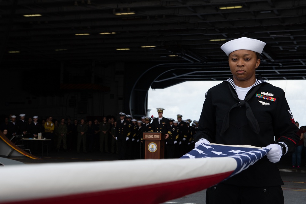 U.S. Navy Religious Programs Specialist 2nd Class Che’lese Bowman, from Clover, Virginia, folds the American flag during a burial at sea