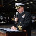 U.S. Navy Cmdr. Dave Dinkins, command chaplain, reads obituaries during a burial at sea