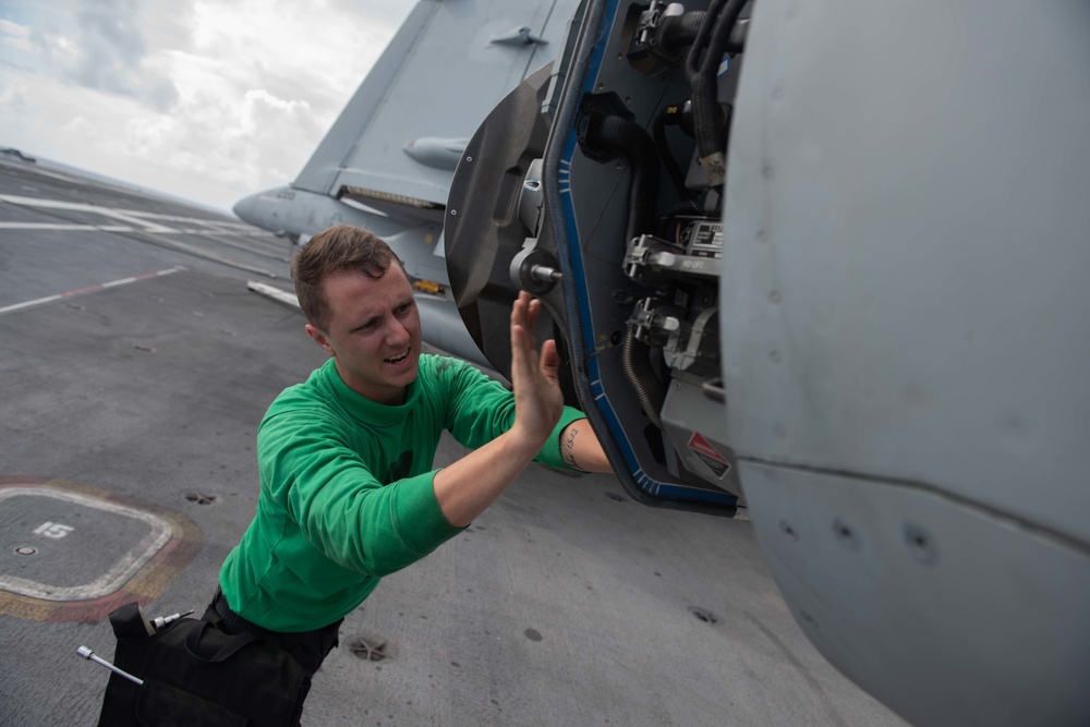 U.S. Navy Aviation Electronics Technician 3rd Class Henry Metzler, from Menifee, California, replaces the radar power supply of an F/A-18 Super Hornet