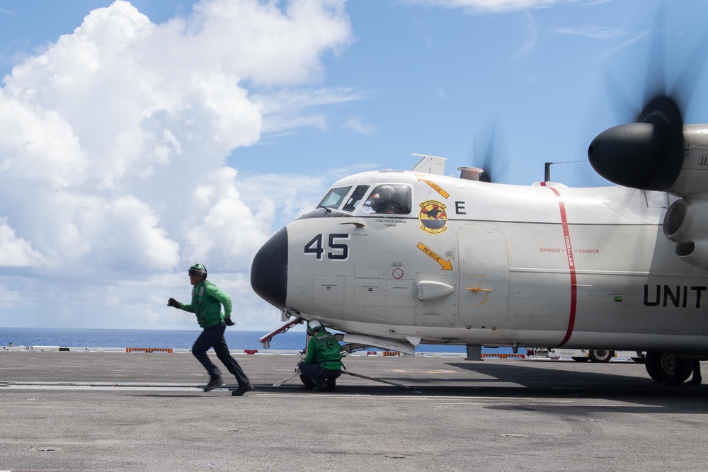 U.S. Sailors prepare a C-2A Greyhound for launch off the flight deck of the USS John C. Stennis