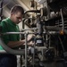 U.S. Sailor scrubs launch valves