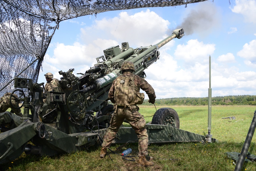 Soldiers fire a M777A2 towed 155 mm howitzer 