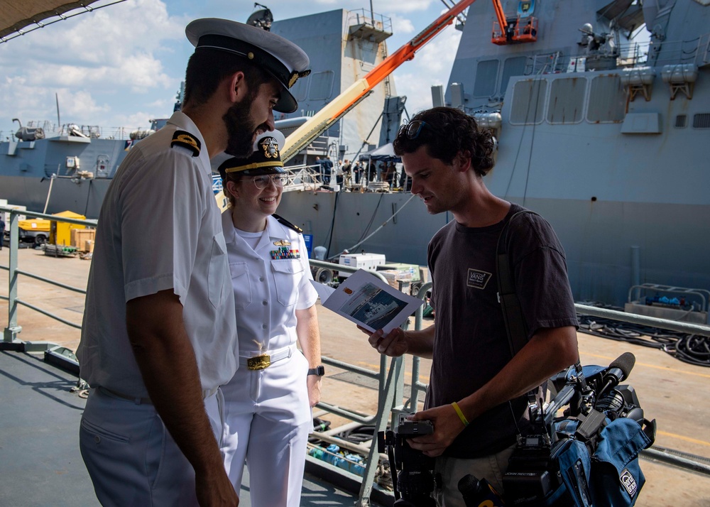 SNMG1 Sailors Greet a News Reporter