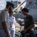 SNMG1 Sailors Greet a News Reporter