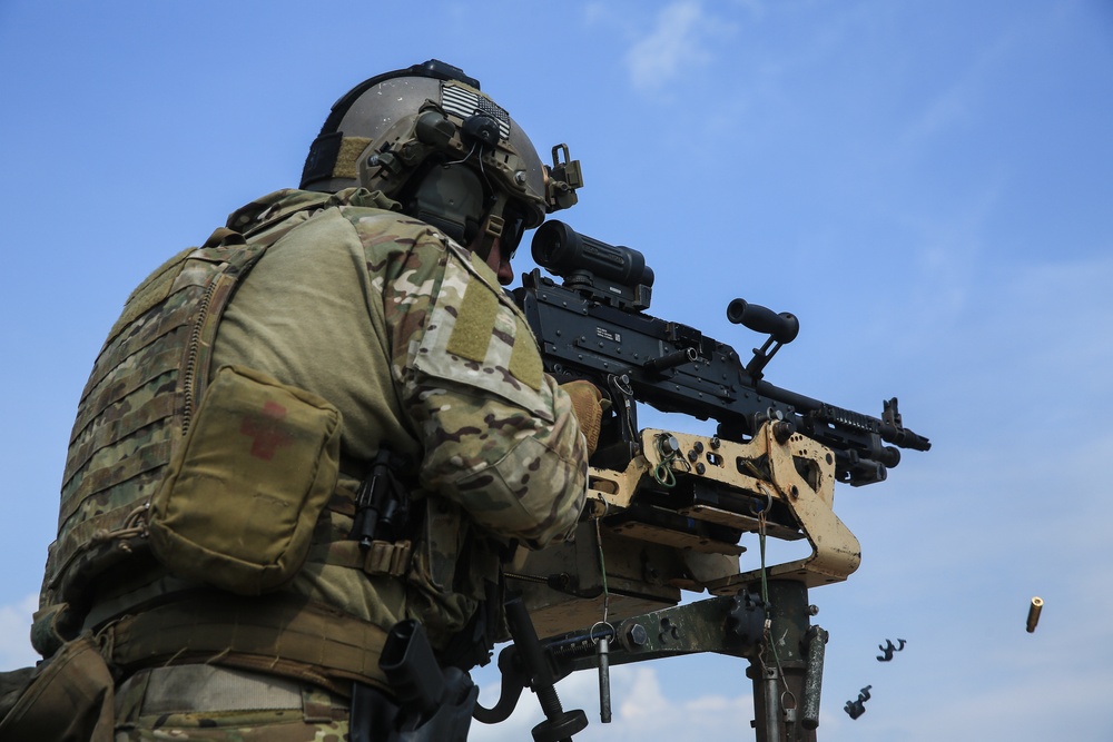 Firing a M240 machine gun during a tactical vehicle live fire