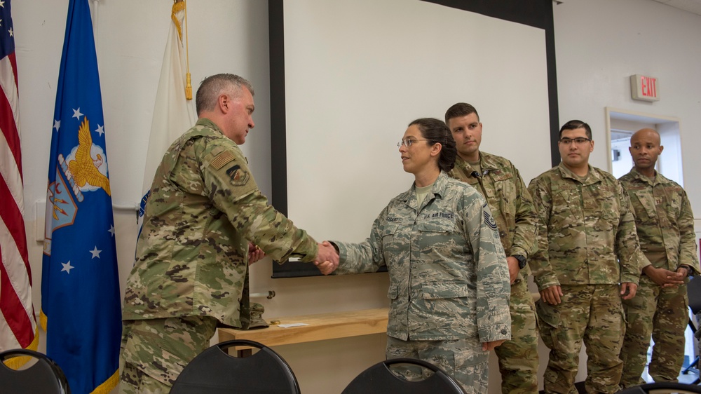 Airmen from the 202nd ISRG get coined at Otis ANGB