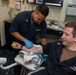 U.S. Sailor draws blood from patient