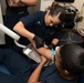 U.S. Sailor draws blood from a patient