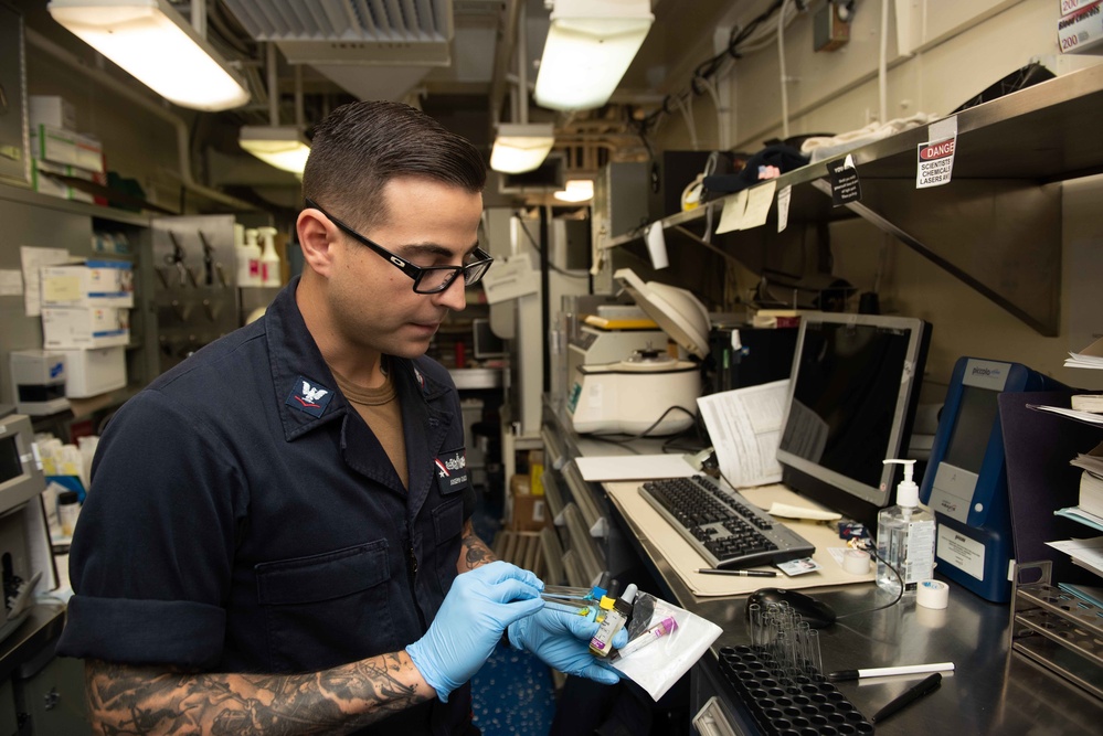 U.S. Sailor examines blood samples
