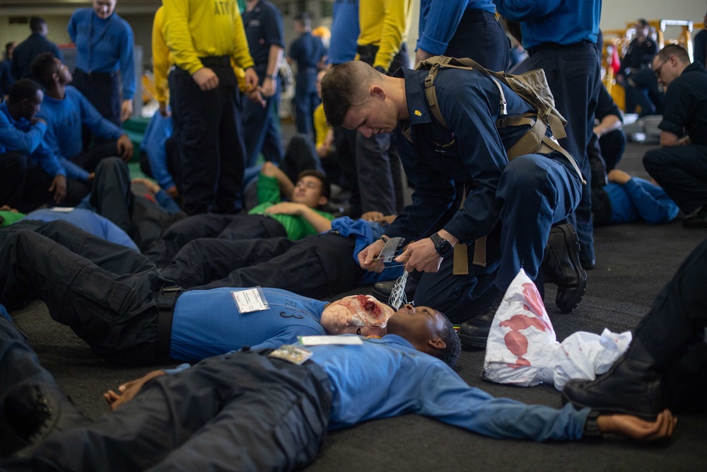 U.S. Sailor tends to a simulated patient during a mass casualty dril