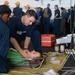 U.S. Sailors tend to a simulated patient during a mass casualty dril